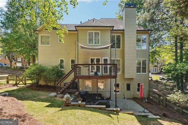 back of house with fence, a patio, a chimney, stairs, and a lawn