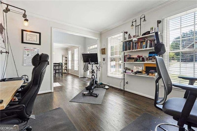 home office featuring crown molding, baseboards, and wood finished floors