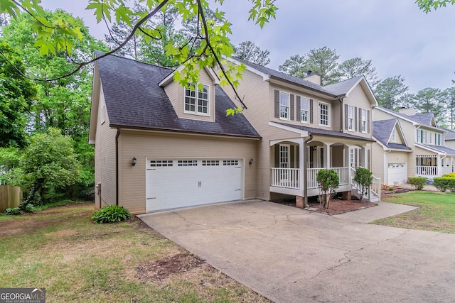 view of front of property featuring roof with shingles, an attached garage, a front lawn, a porch, and driveway