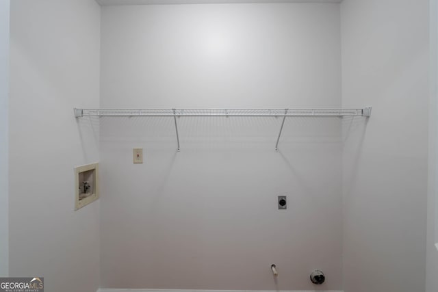 laundry area with laundry area, hookup for a washing machine, and electric dryer hookup