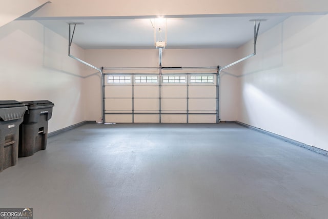 garage with baseboards and a garage door opener