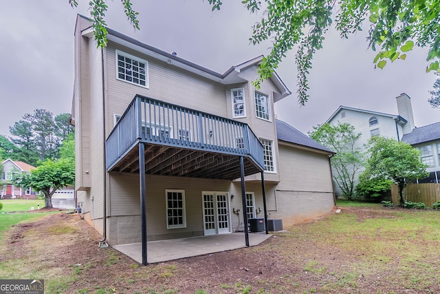 rear view of property with a patio, central AC unit, and a wooden deck