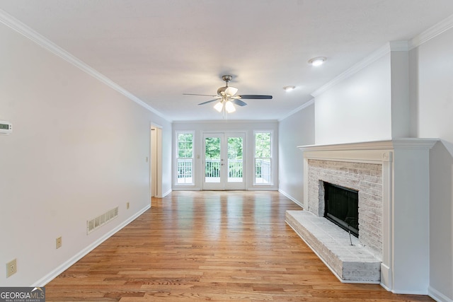 unfurnished living room featuring crown molding, ceiling fan, light wood-type flooring, and visible vents