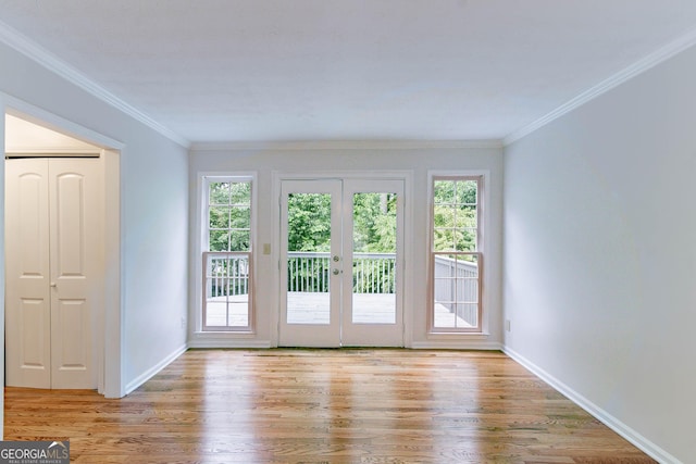 doorway to outside featuring baseboards, a healthy amount of sunlight, and light wood-style floors