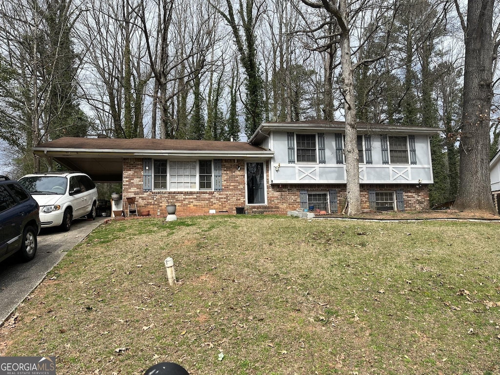 8474 Magnolia Dr, Jonesboro, GA 30238 - split level home with an attached carport, brick siding, a front lawn, and aphalt driveway