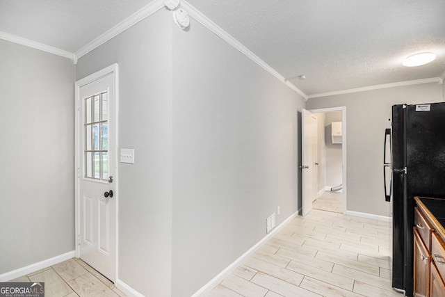 corridor featuring crown molding, a textured ceiling, and baseboards