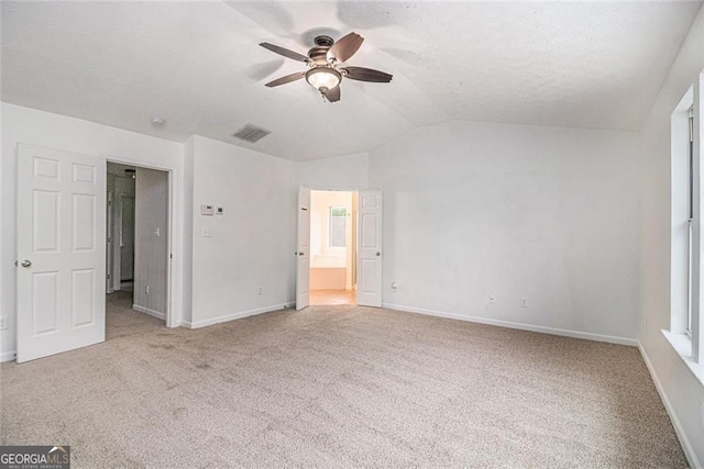 7454 Silver Arrow Trl SE, Austell, GA 30168 - unfurnished bedroom with carpet, lofted ceiling, a ceiling fan, and ensuite bath
