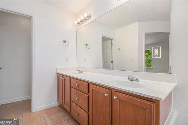 7454 Silver Arrow Trl SE, Austell, GA 30168 - bathroom with double vanity, a textured ceiling, and tile patterned flooring