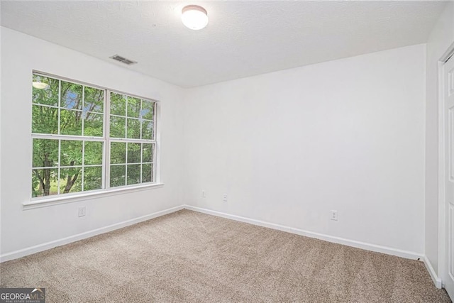7454 Silver Arrow Trl SE, Austell, GA 30168 - carpeted spare room with baseboards and a textured ceiling