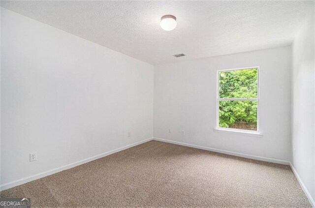 7454 Silver Arrow Trl SE, Austell, GA 30168 - spare room featuring carpet and a textured ceiling