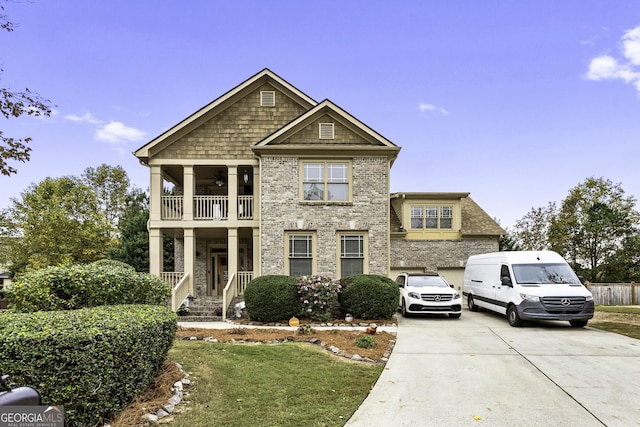 1114 Ivey Chase Pl, Dacula, GA 30019 - view of front of home featuring a balcony, driveway, brick siding, a ceiling fan, and a front lawn