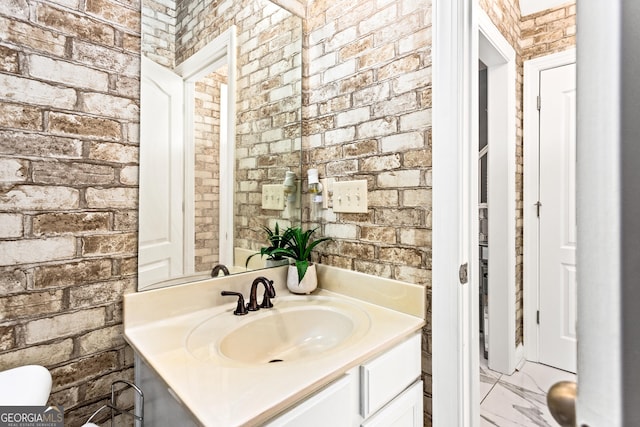 1114 Ivey Chase Pl, Dacula, GA 30019 - bathroom featuring vanity, brick wall, and toilet