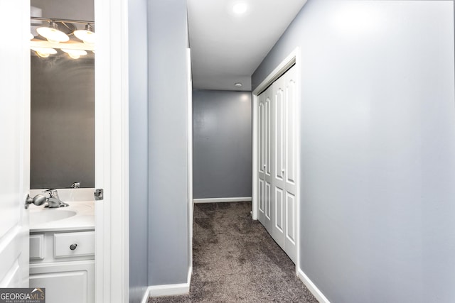 1114 Ivey Chase Pl, Dacula, GA 30019 - hall featuring dark colored carpet, a sink, and baseboards