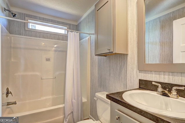 bathroom featuring vanity, shower / tub combo with curtain, toilet, and wallpapered walls