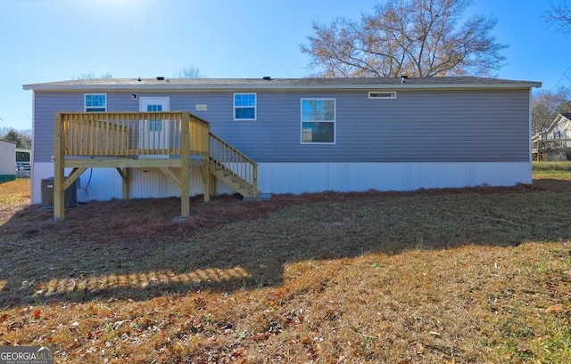 rear view of property featuring central AC, a wooden deck, and stairs