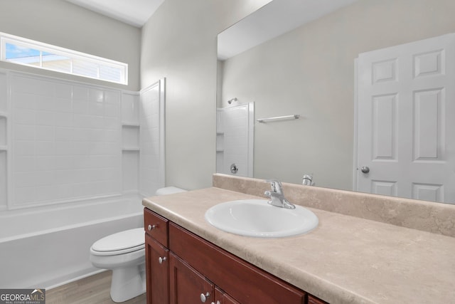 full bath featuring vanity, shower / bathtub combination, toilet, and wood finished floors
