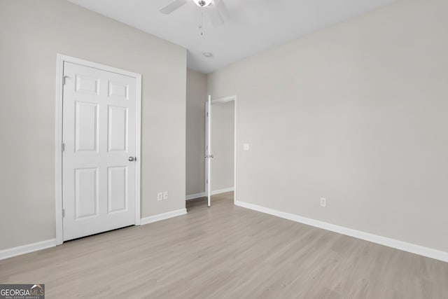 unfurnished bedroom with baseboards, ceiling fan, and light wood-type flooring
