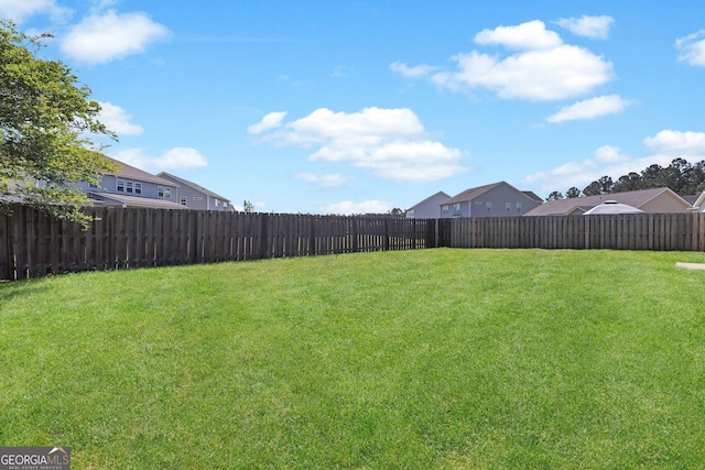 view of yard with a fenced backyard