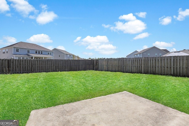 view of yard with a patio, a residential view, and a fenced backyard