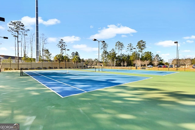 view of tennis court featuring fence