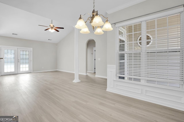 interior space featuring visible vents, wood finished floors, arched walkways, ceiling fan with notable chandelier, and vaulted ceiling