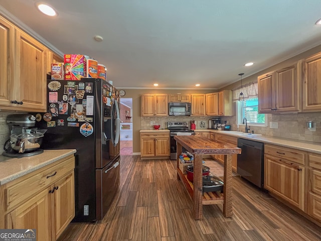 kitchen with decorative backsplash, dark wood-type flooring, light countertops, a sink, and stainless steel appliances