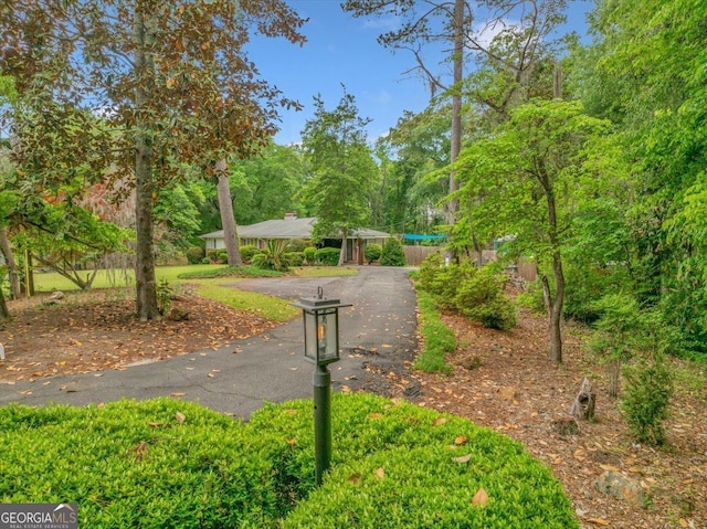 view of community with aphalt driveway