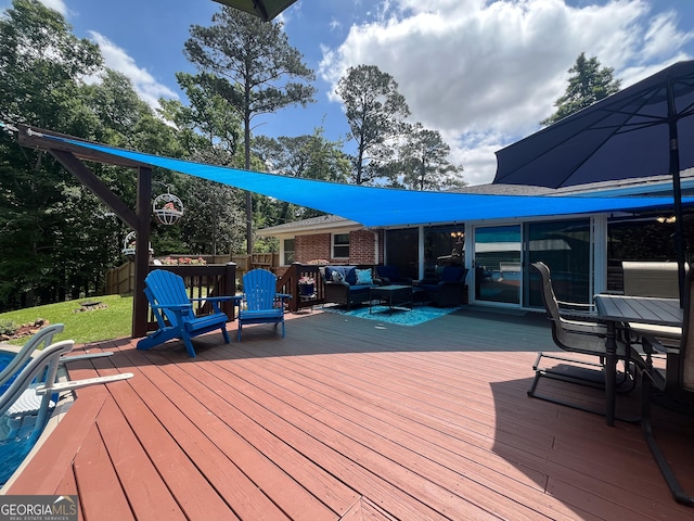 deck featuring a yard and an outdoor living space