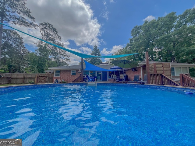 view of swimming pool featuring a fenced in pool and fence