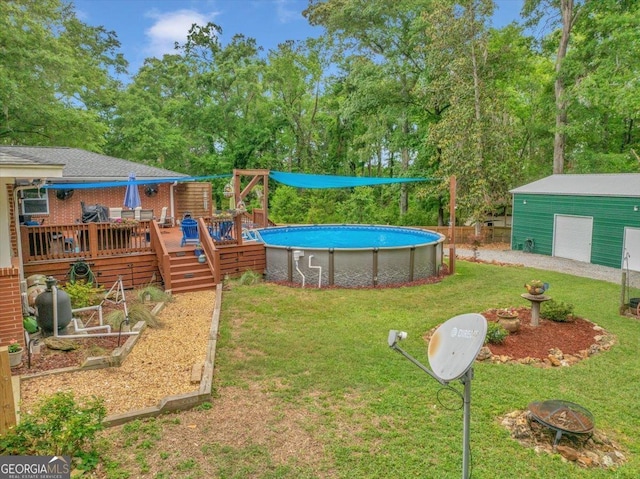 view of yard with a deck, a fire pit, an outdoor pool, and a garage