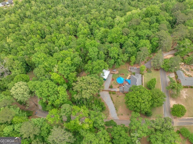 drone / aerial view featuring a view of trees
