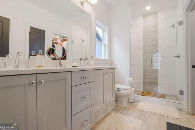 3272 Stillwood Dr, Atlanta, GA 30354 - bathroom featuring double vanity, a sink, a stall shower, and toilet