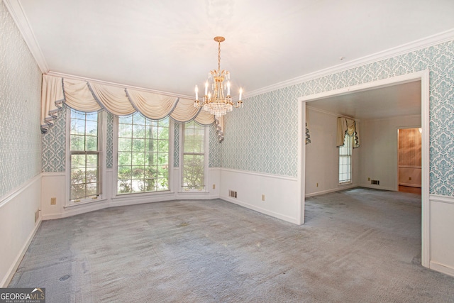 unfurnished dining area featuring an inviting chandelier, crown molding, a healthy amount of sunlight, and wallpapered walls