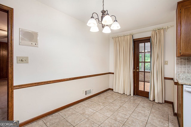 unfurnished dining area with light tile patterned flooring, baseboards, visible vents, and an inviting chandelier