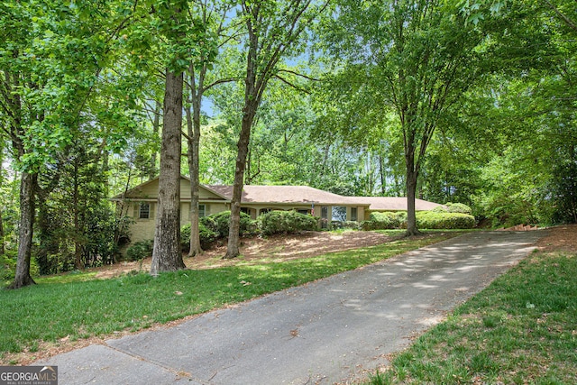 single story home featuring aphalt driveway