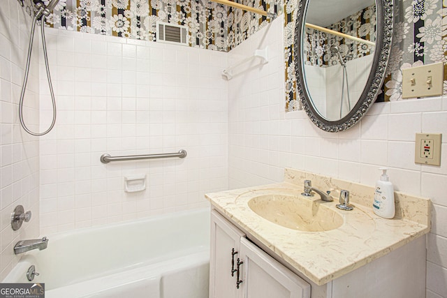 bathroom with tile walls, backsplash, vanity, and shower / bath combination with curtain