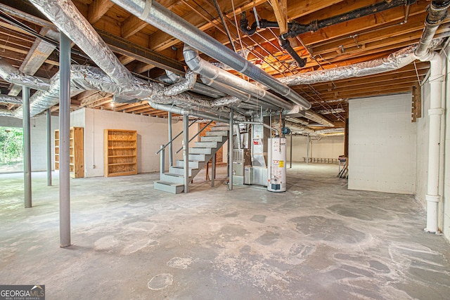 basement with heating unit, gas water heater, and stairs