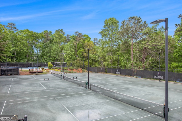 view of tennis court featuring fence