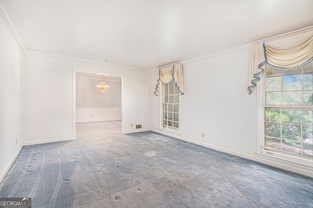 unfurnished room with crown molding, baseboards, carpet, and a notable chandelier