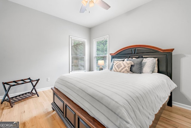 bedroom with baseboards, light wood-style flooring, and ceiling fan