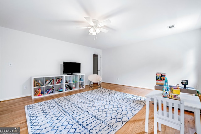 game room with visible vents, baseboards, ceiling fan, and wood finished floors
