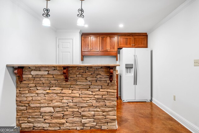 kitchen featuring crown molding, white refrigerator with ice dispenser, brown cabinets, finished concrete floors, and hanging light fixtures