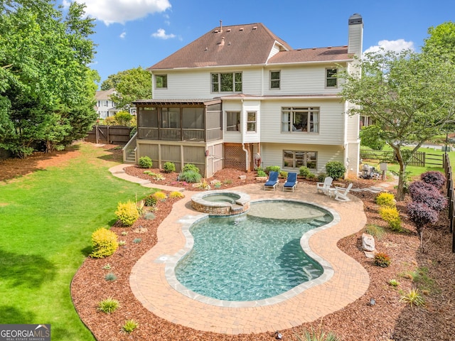 rear view of property with a lawn, a patio, a sunroom, and a fenced backyard