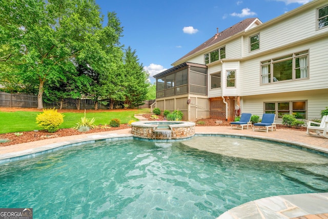 view of pool featuring a yard, a pool with connected hot tub, and a fenced backyard