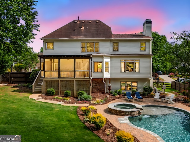 back of property featuring a chimney, a patio area, fence, a yard, and stairs