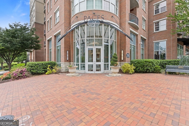 property entrance with french doors and brick siding