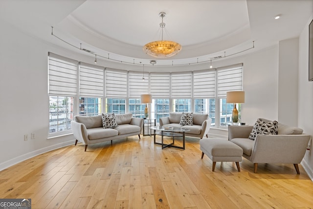 living room featuring baseboards, visible vents, and light wood-style flooring