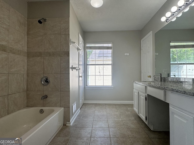 full bathroom featuring shower / tub combination, vanity, a textured ceiling, tile patterned floors, and baseboards