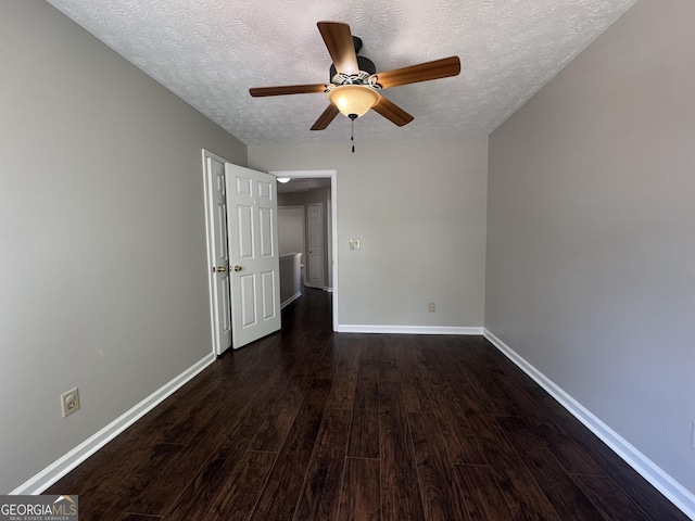 unfurnished bedroom with baseboards, a textured ceiling, ceiling fan, and dark wood finished floors