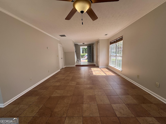 empty room with crown molding, baseboards, and visible vents